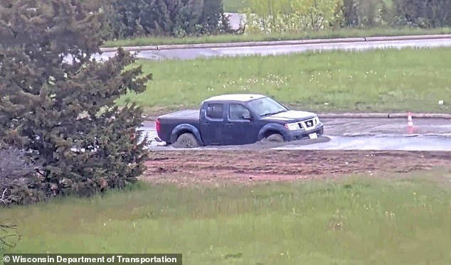 Wisconsin driver ignores road closure warning and plows into wet concrete