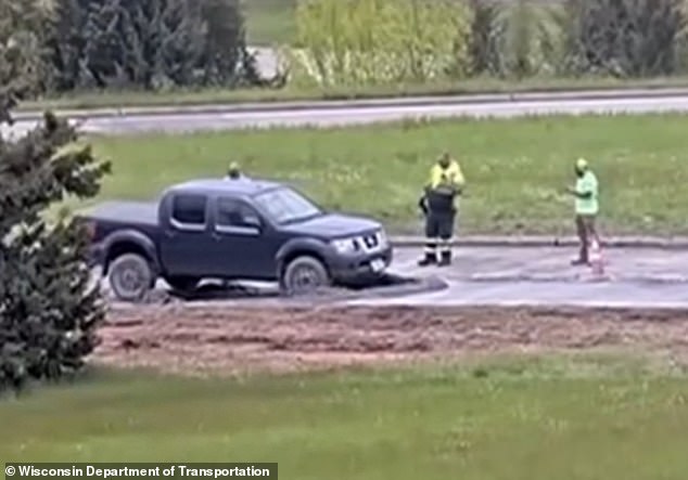 Wisconsin driver ignores road closure warning and plows into wet concrete