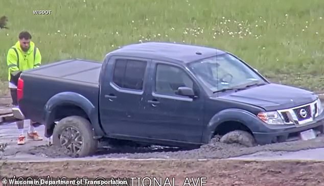 Wisconsin driver ignores road closure warning and plows into wet concrete