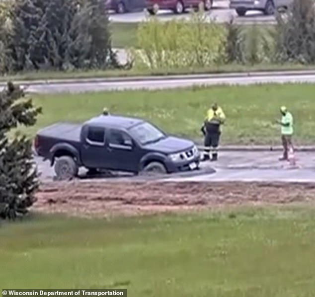 Wisconsin driver ignores road closure warning and plows into wet concrete